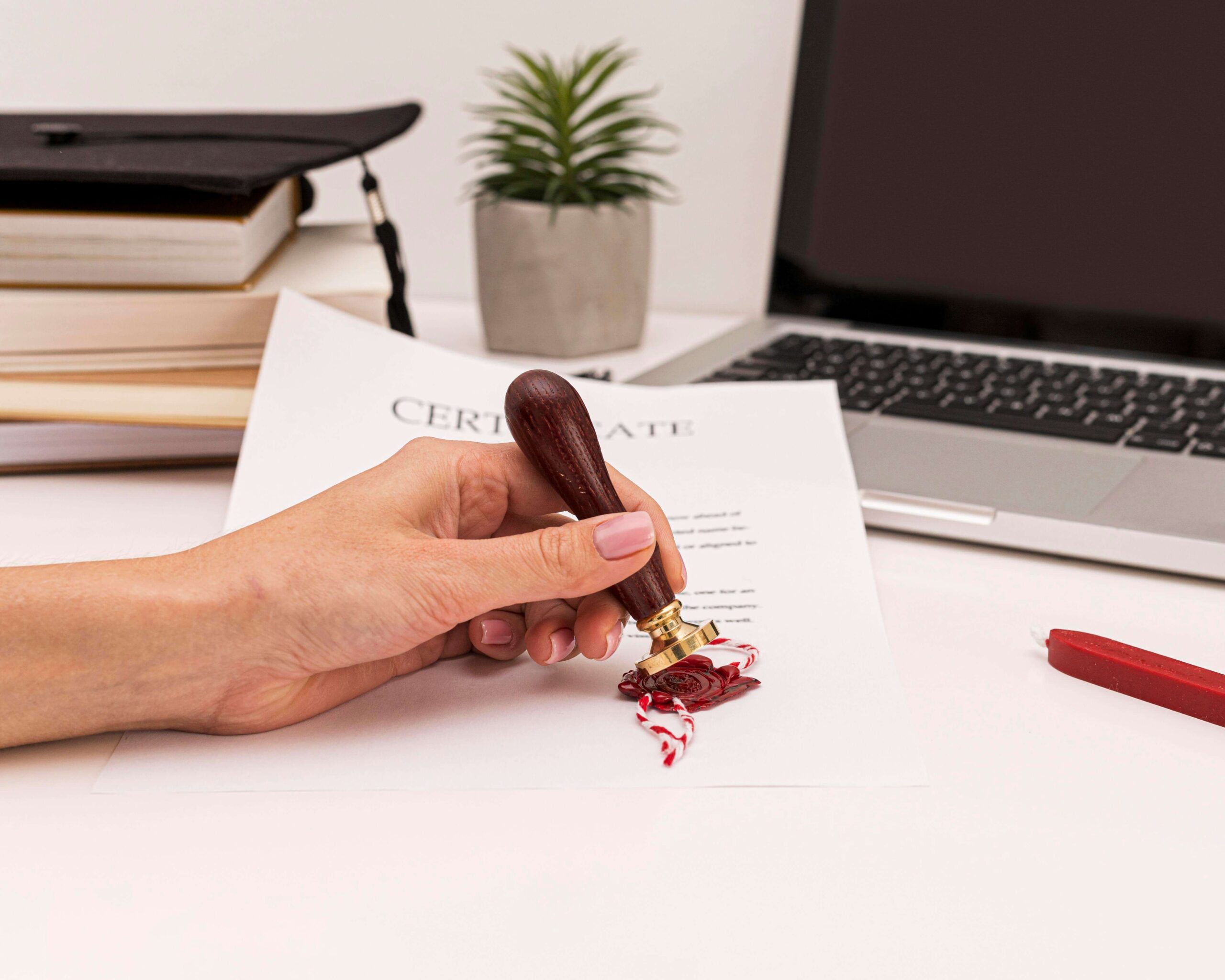 person-using-wax-seal-graduation-diploma-certificate